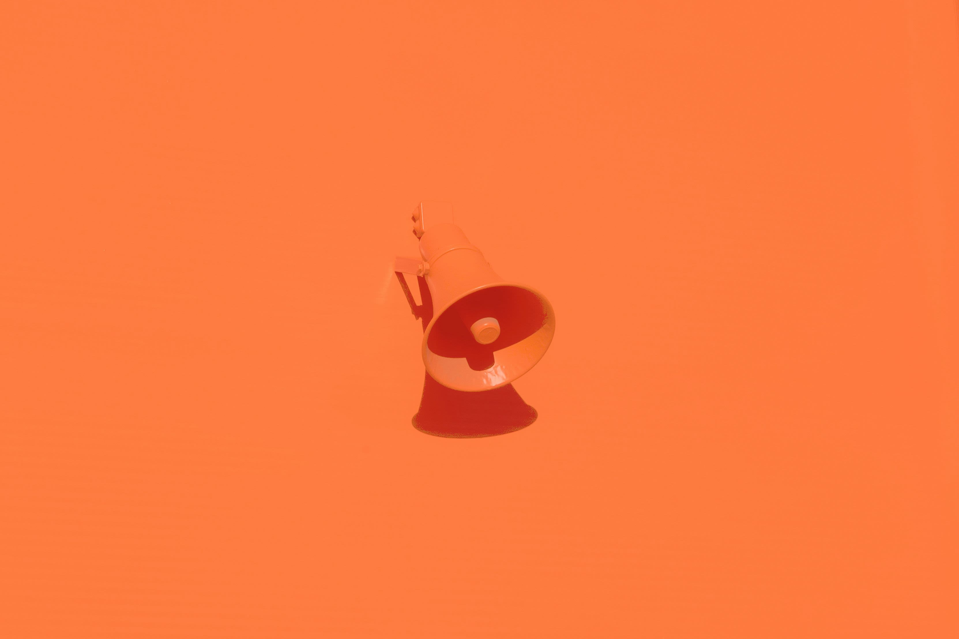 orange megaphone on orange wall