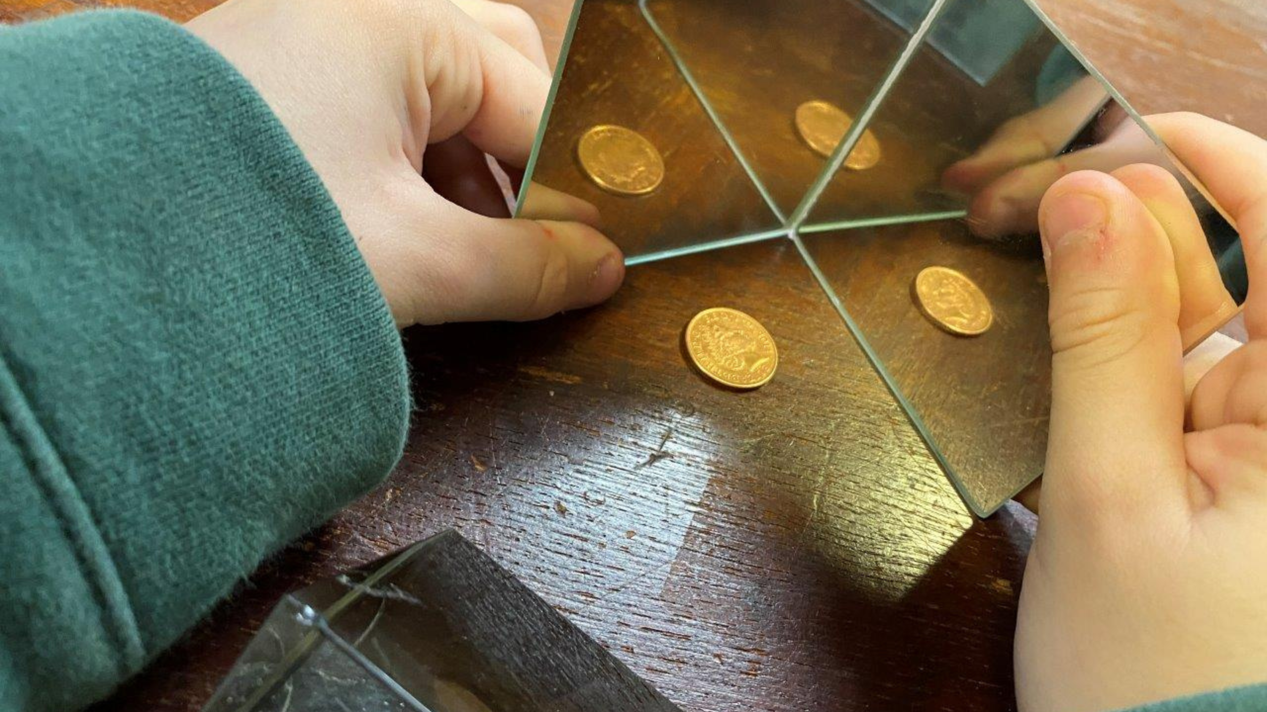 a wooden stand with three metal balls on it